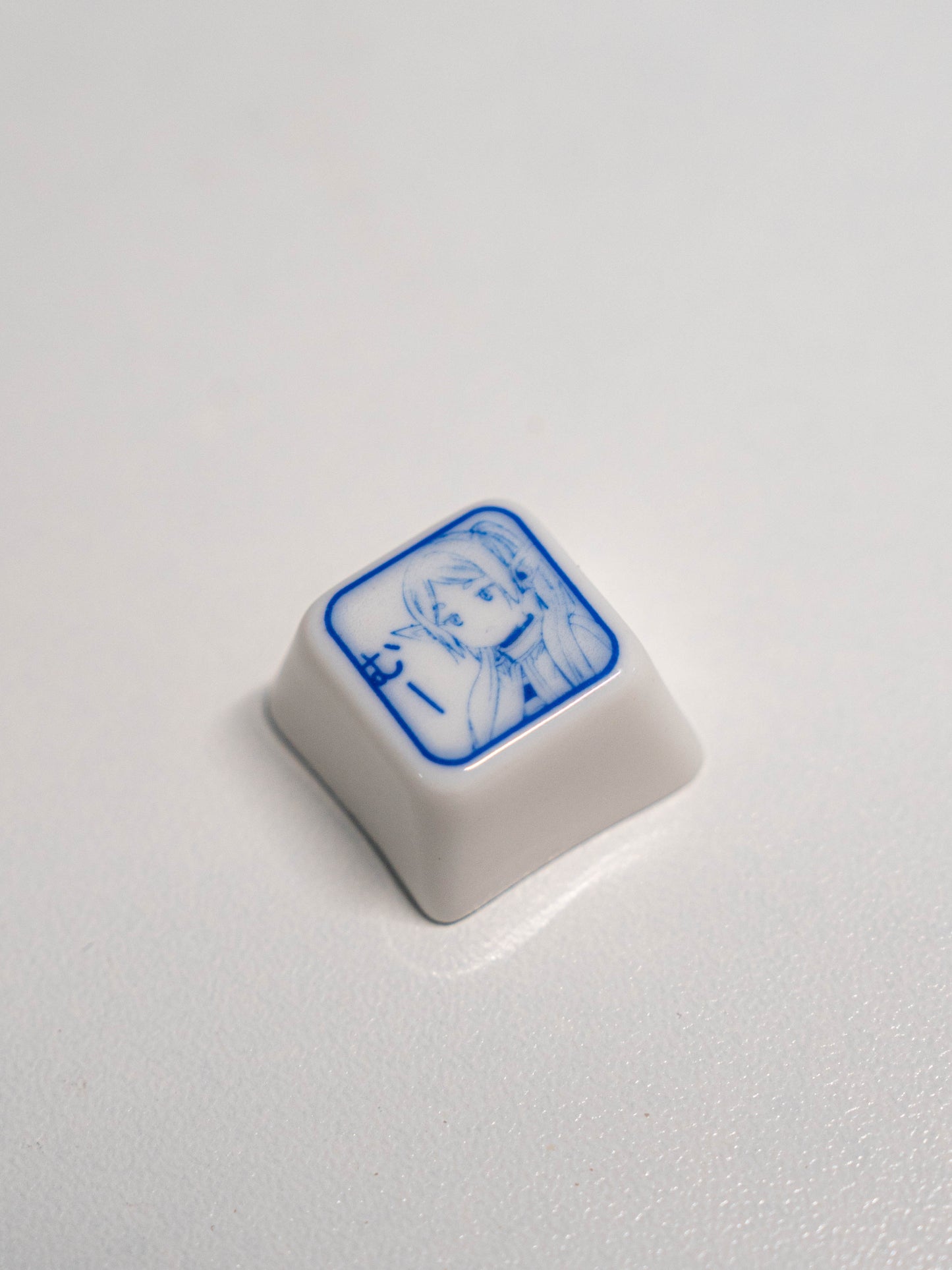 Frieren-themed artisan keycap crafted from ceramic, inspired by the anime character's serene design.