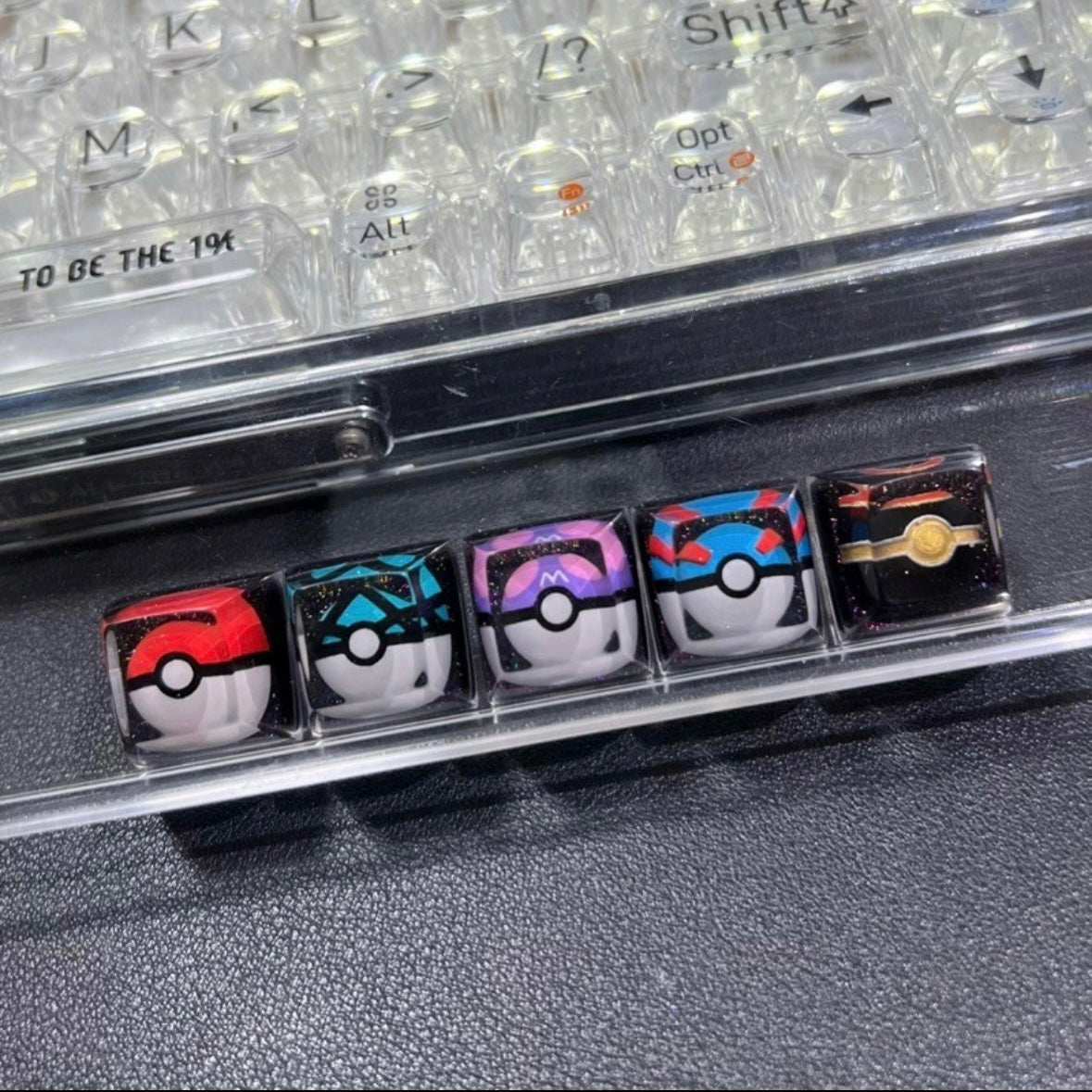 "Capture the essence of Pokémon with our 'Pokémon's Pokeball' Artisan Custom Keycaps. These meticulously crafted keycaps pay homage to the iconic Pokéball design, adding a playful touch to your keyboard. Each keycap is a unique collectible, showcasing your love for the Pokémon universe. Elevate your keyboard setup with these delightful artisan keycaps and embark on a typing adventure." ⚡🔴💻 #KeyboardAccessories #ArtisanKeycaps #PokémonLove
