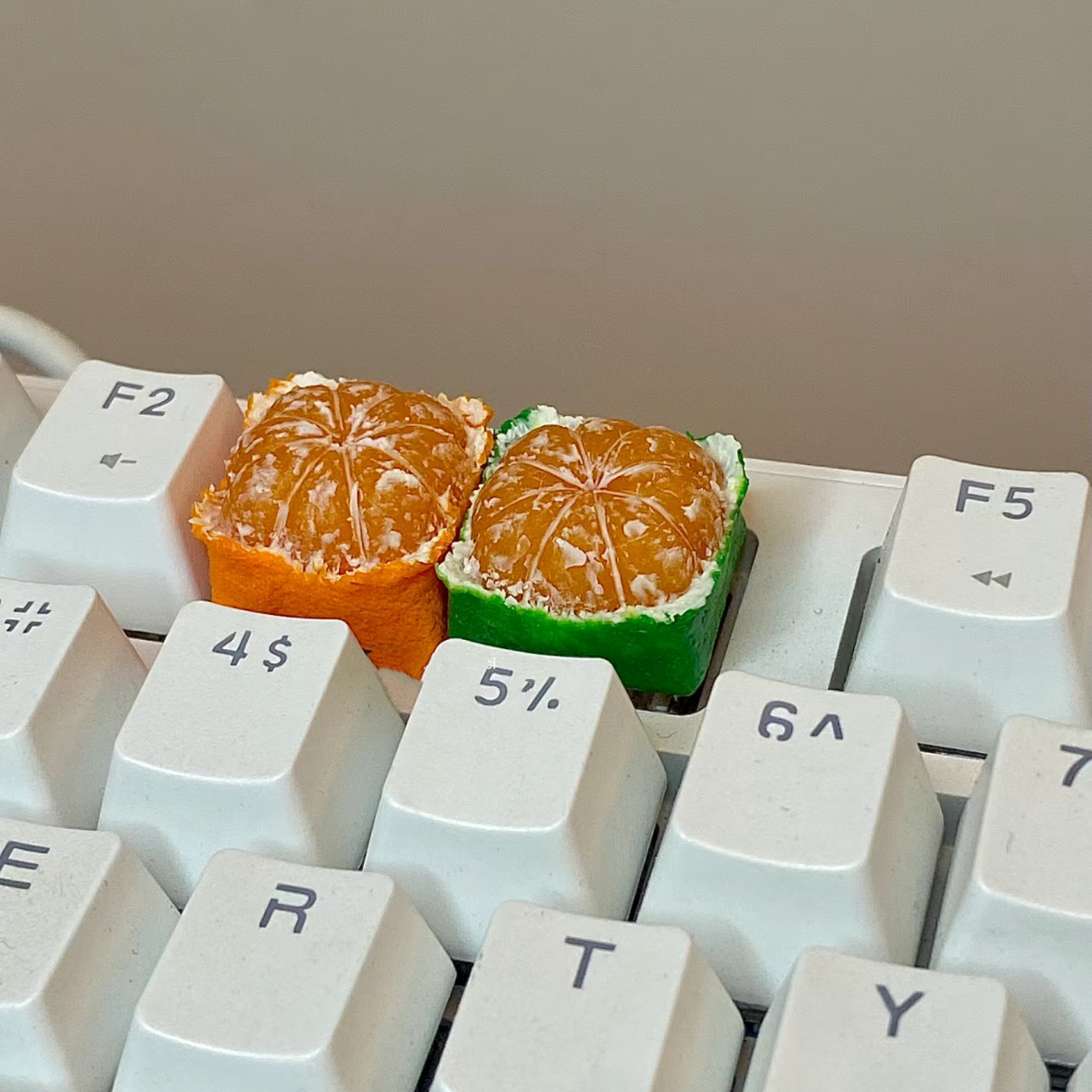 Custom keycap featuring a square design of an Orange or Tangerine, designed for artisan keycap enthusiasts.