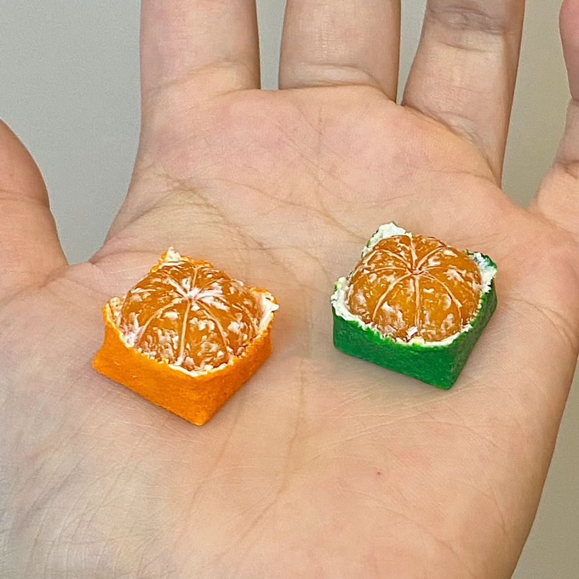 Custom keycap featuring a square design of an Orange or Tangerine, designed for artisan keycap enthusiasts.