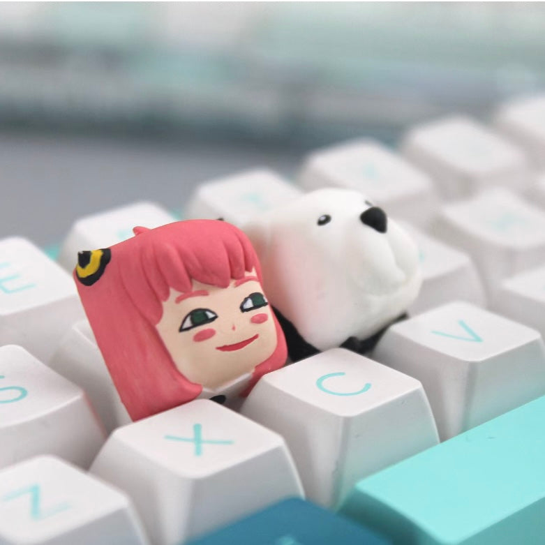 Anya Forger pink keycap for mechanical keyboards, showcasing her cheeky smile and fun-loving spirit from SPY x FAMILY.
