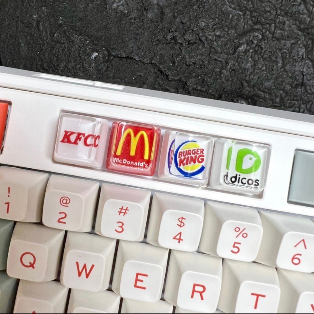 "Show your love for fast food and coffee giants with our custom artisan keycaps featuring iconic logos from Burger King, McDonald's, Starbucks, and KFC. These keycaps are a unique blend of foodie culture and keyboard aesthetics. Crafted with precision, they make a deliciously stylish addition to your setup. Express your passion for your favorite brands with these eye-catching keycaps." 🍔🍟🍗🍕☕💻 #KeyboardAccessories #ArtisanKeycaps #FastFoodLove