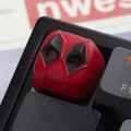 Close-up of aiheystudio’s Deadpool keycap featuring masked design with detailed paintwork.
