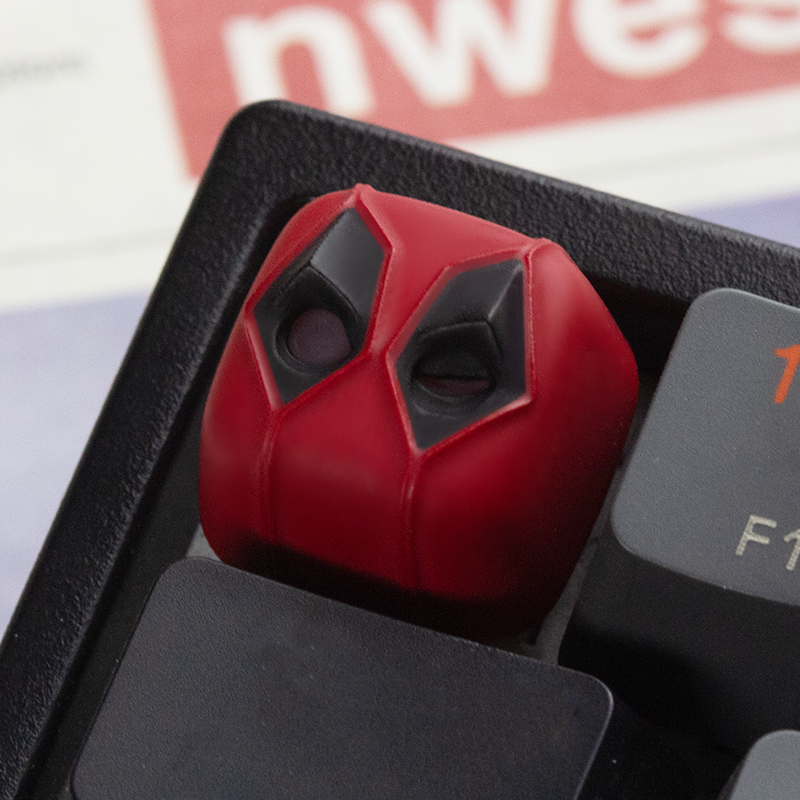 Close-up of aiheystudio’s Deadpool keycap featuring masked design with detailed paintwork.
