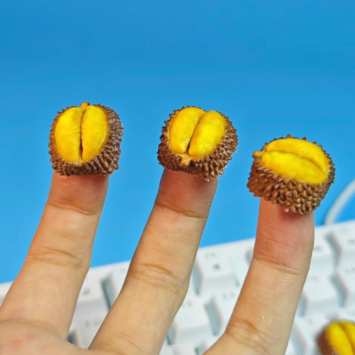 "Introducing our Durian Artisan Keycaps, inspired by the infamous tropical fruit. These keycaps feature the distinctive thorny texture of a durian, meticulously simulated to add a unique touch to your keyboard. While the real fruit has a strong odor, these keycaps bring the durian's visual charm without the scent. Elevate your keyboard with these one-of-a-kind, durian-inspired artisan keycaps." 🌳🍈💻 #KeyboardAccessories #ArtisanKeycaps #DurianDesign