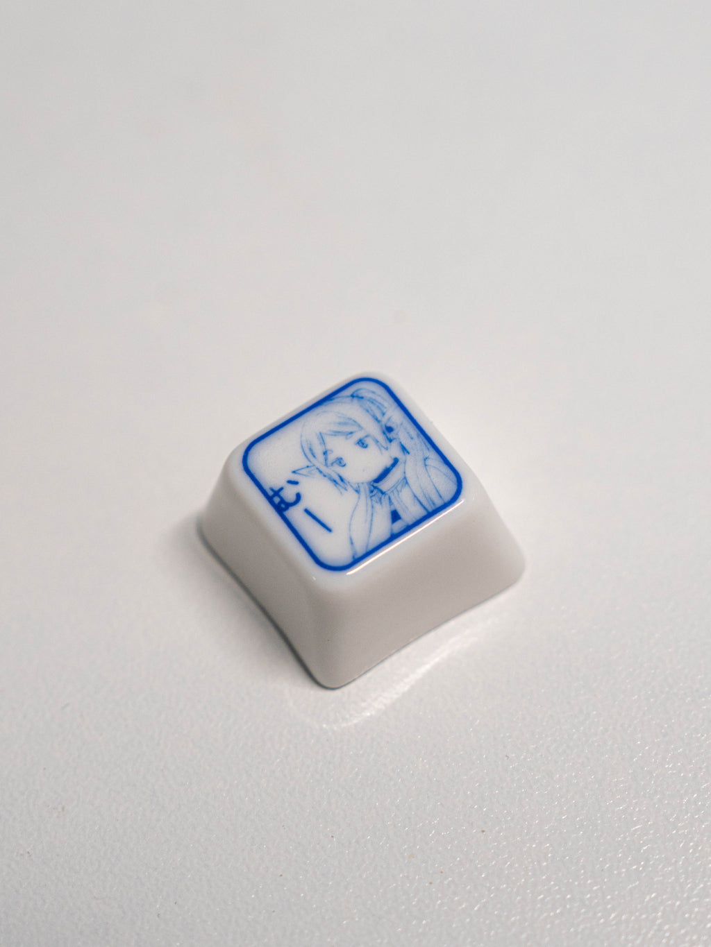 Frieren-themed artisan keycap crafted from ceramic, inspired by the anime character's serene design.