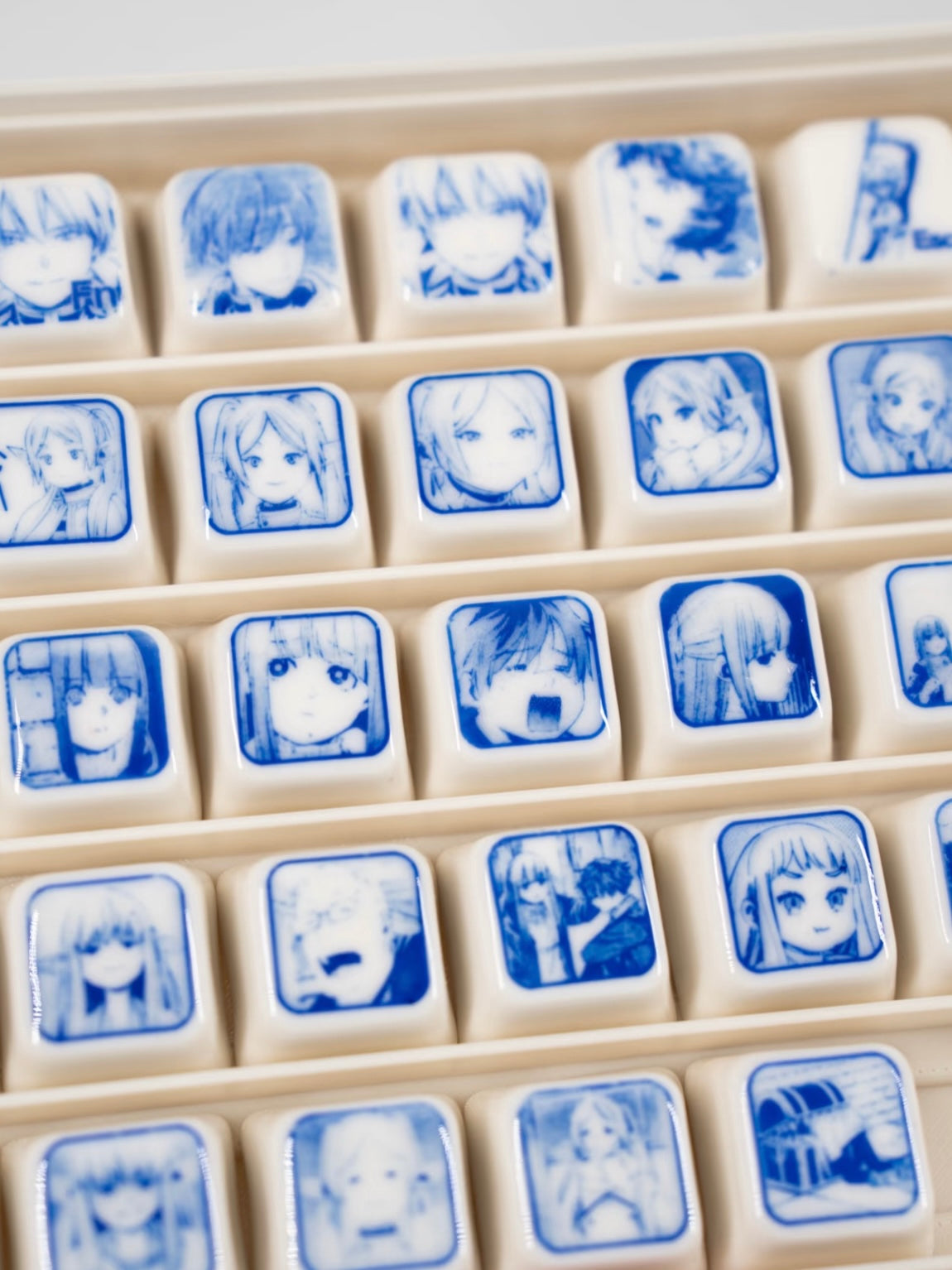 Close-up of ceramic Frieren keycap with delicate hand-painted details and glossy finish.