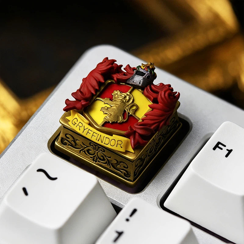 Handmade Harry Potter inspired Hogwarts crest resin keycap with detailed magical emblem designs. The layered resin craftsmanship creates a three-dimensional collectible accessory for custom mechanical keyboards, gaming desks, and fantasy themed setups.