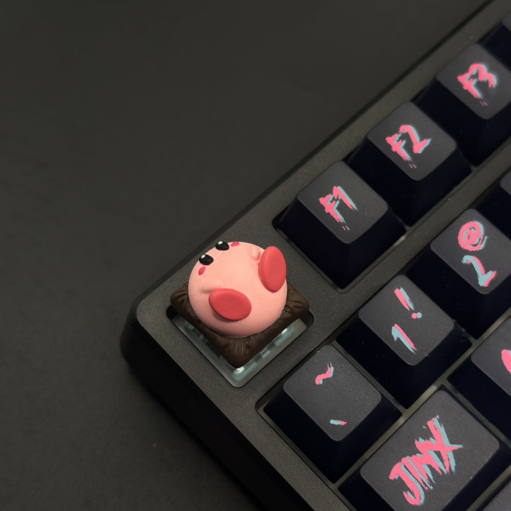 This custom artisan keycap features Kirby in all his adorable glory, meticulously crafted to add a touch of charm and nostalgia to your setup.