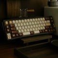 NICO Tiramisu inspired PBT keycap set featuring warm coffee brown and creamy white colors. Designed for mechanical keyboards, this minimalist dessert themed keycap set combines cozy aesthetics, durable PBT material, and elegant dye sublimation details for a refined desktop setup.