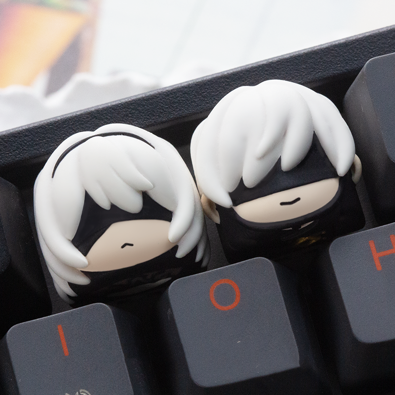NieR: Automata-inspired keycap with 2B and 9S details, capturing the game’s futuristic essence for your keyboard.
