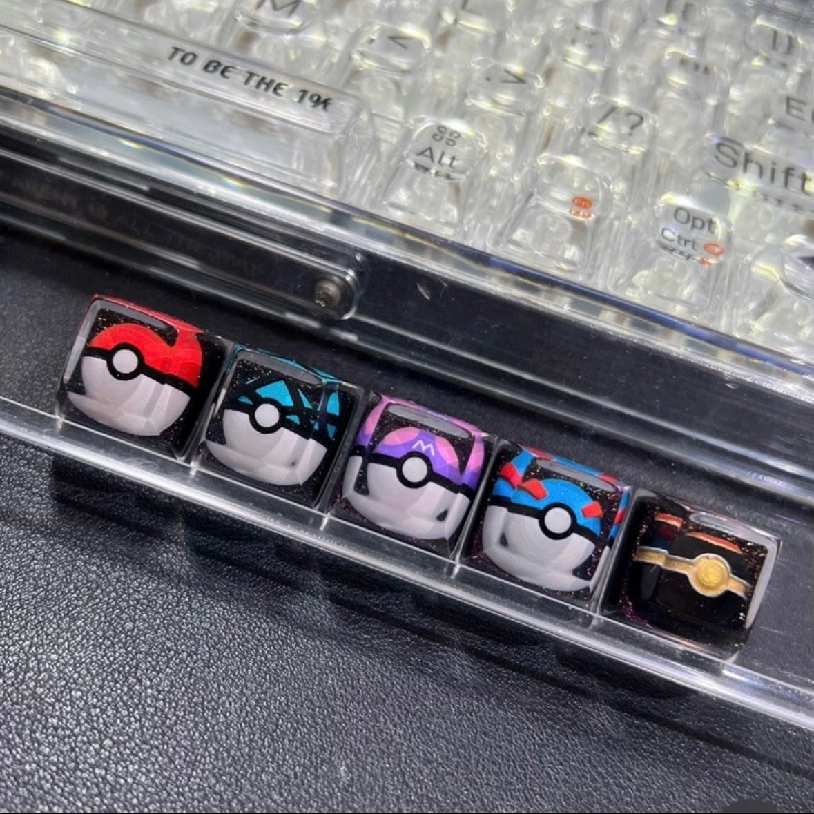 "Capture the essence of Pokémon with our 'Pokémon's Pokeball' Artisan Custom Keycaps. These meticulously crafted keycaps pay homage to the iconic Pokéball design, adding a playful touch to your keyboard. Each keycap is a unique collectible, showcasing your love for the Pokémon universe. Elevate your keyboard setup with these delightful artisan keycaps and embark on a typing adventure." ⚡🔴💻 #KeyboardAccessories #ArtisanKeycaps #PokémonLove