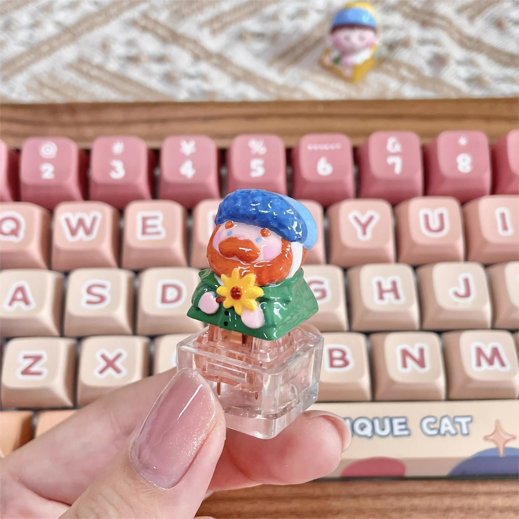 "Indulge in the artistic charm of our Resin Van Gogh Artisan Keycap – a lovable chibi rendition of Van Gogh holding a sunflower. This keycap is not just a functional accessory; it's a true masterpiece. Crafted from high-quality resin and coated with a surface layer, it exudes the delicate elegance of ceramic while being crafted from resin material. Transform your keyboard into a canvas of art with this adorable keycap, where every keystroke becomes a stroke of cuteness and craftsmanship. 