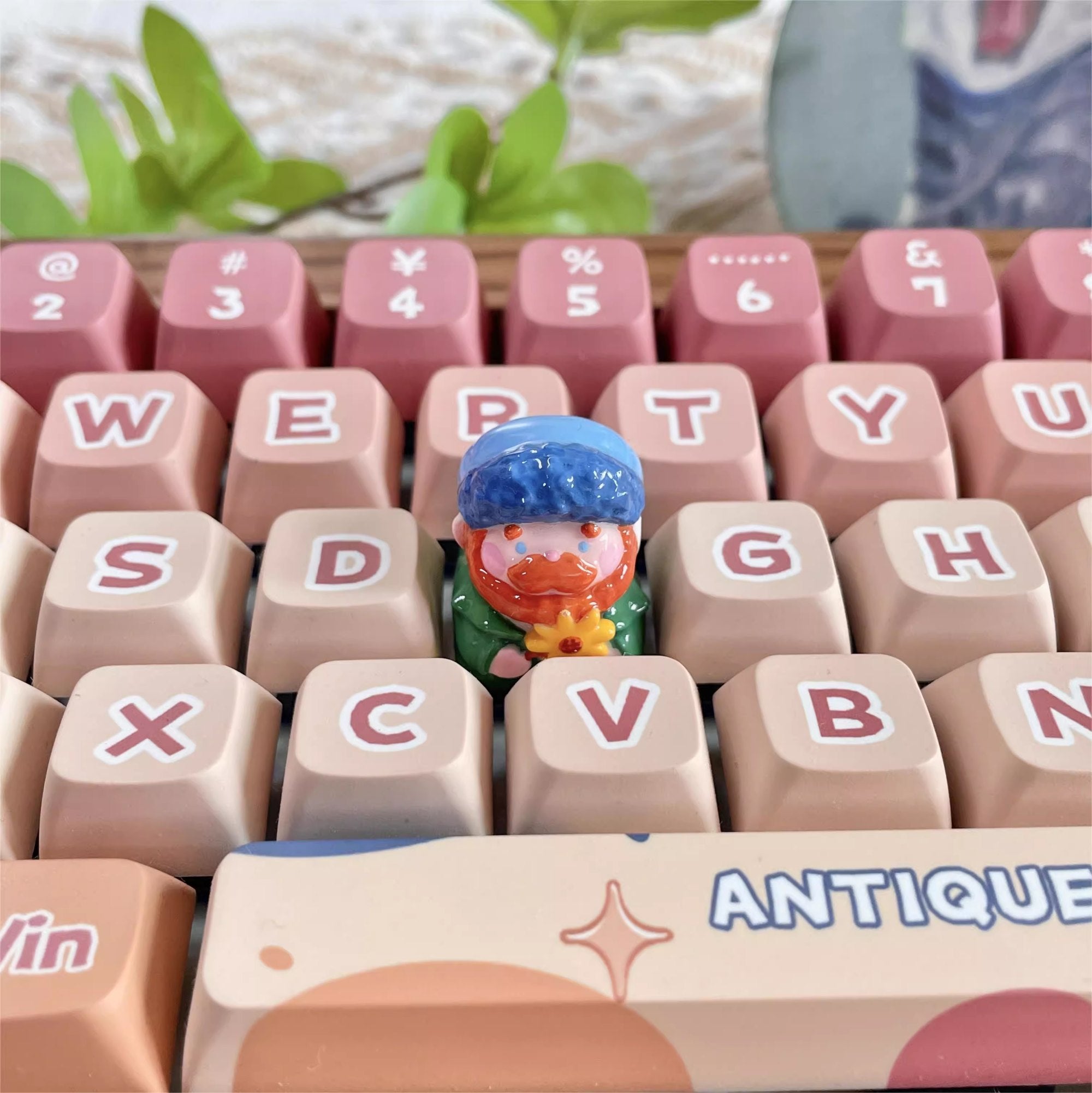"Indulge in the artistic charm of our Resin Van Gogh Artisan Keycap – a lovable chibi rendition of Van Gogh holding a sunflower. This keycap is not just a functional accessory; it's a true masterpiece. Crafted from high-quality resin and coated with a surface layer, it exudes the delicate elegance of ceramic while being crafted from resin material. Transform your keyboard into a canvas of art with this adorable keycap, where every keystroke becomes a stroke of cuteness and craftsmanship. 
