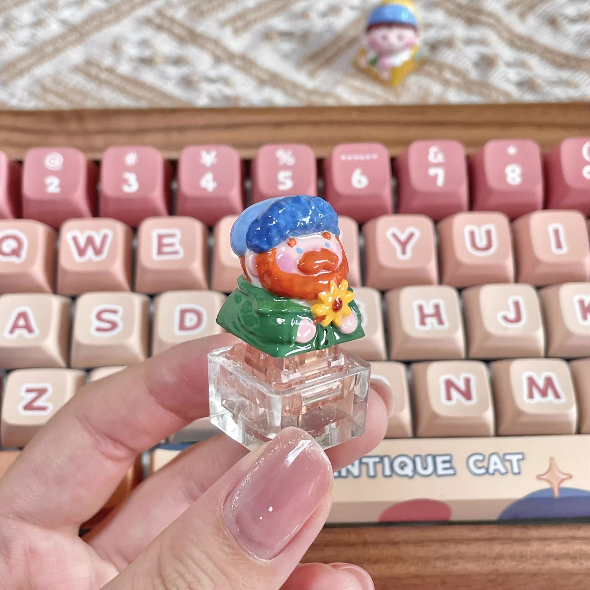 "Indulge in the artistic charm of our Resin Van Gogh Artisan Keycap – a lovable chibi rendition of Van Gogh holding a sunflower. This keycap is not just a functional accessory; it's a true masterpiece. Crafted from high-quality resin and coated with a surface layer, it exudes the delicate elegance of ceramic while being crafted from resin material. Transform your keyboard into a canvas of art with this adorable keycap, where every keystroke becomes a stroke of cuteness and craftsmanship. 