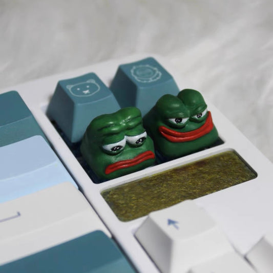 Sad Frog, Funny Frog Green Frog Custom Artisan Keycaps Custom Artisan Keycaps set featuring Sad Frog and Funny Frog, adding a playful touch to your mechanical keyboard with vibrant green design.

