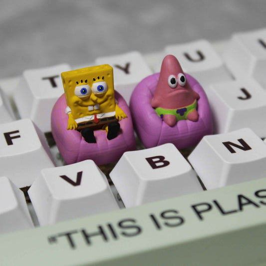 "Dive into the whimsical world of Bikini Bottom with our SpongeBob and Patrick Custom Artisan Keycaps. These 3D-printed keycaps are not just accessories; they're a playful homage to the iconic duo. Imagine SpongeBob asking, 'Hey Patrick, do you know what's funnier than 24?' and Patrick responding, 'Umm, 25?' Each keystroke becomes a snippet of their hilarious banter. Crafted with precision and humor, these keycaps bring the charm of SpongeBob and Patrick to your fingertips. 