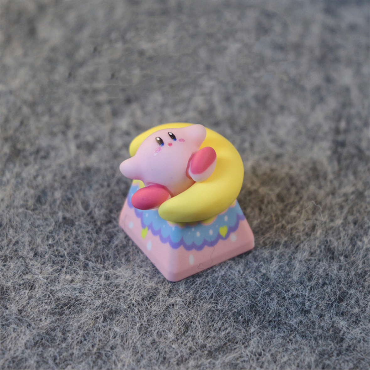Unique artisan keycap showcasing Kirby and a crescent moon, crafted with vibrant colors and intricate details for a playful touch.
