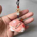 Hand-carved Yae Miko wooden keychain featuring intricate details, perfect as a bag charm or keyring for Genshin Impact fans.
