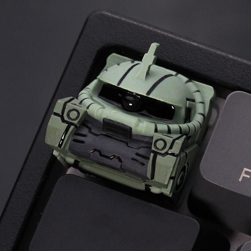Zaku II artisan keycap by aiheystudio in green or red, inspired by Mobile Suit Gundam mecha design.
