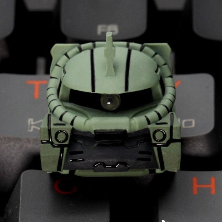 Close-up of aiheystudio’s Zaku II keycap with mono-eye sculpt and mechanical detailing.
