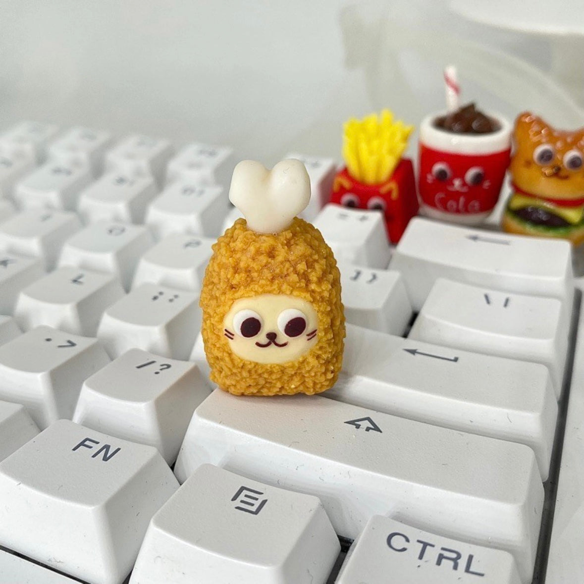 "Indulge in the deliciously whimsical world of our 'Fried Food on the Keyboard' Artisan Keycap. This custom keycap is a playful fusion of keyboard aesthetics and the joy of fried treats. Crafted with precision, it features a delectable assortment of fried foods right on your keyboard. Whether you're a foodie or just want a unique conversation starter, these keycaps add a delightful touch to your setup." 🍟🍔🍗🍕💻 #KeyboardAccessories #ArtisanKeycaps #FoodieFun