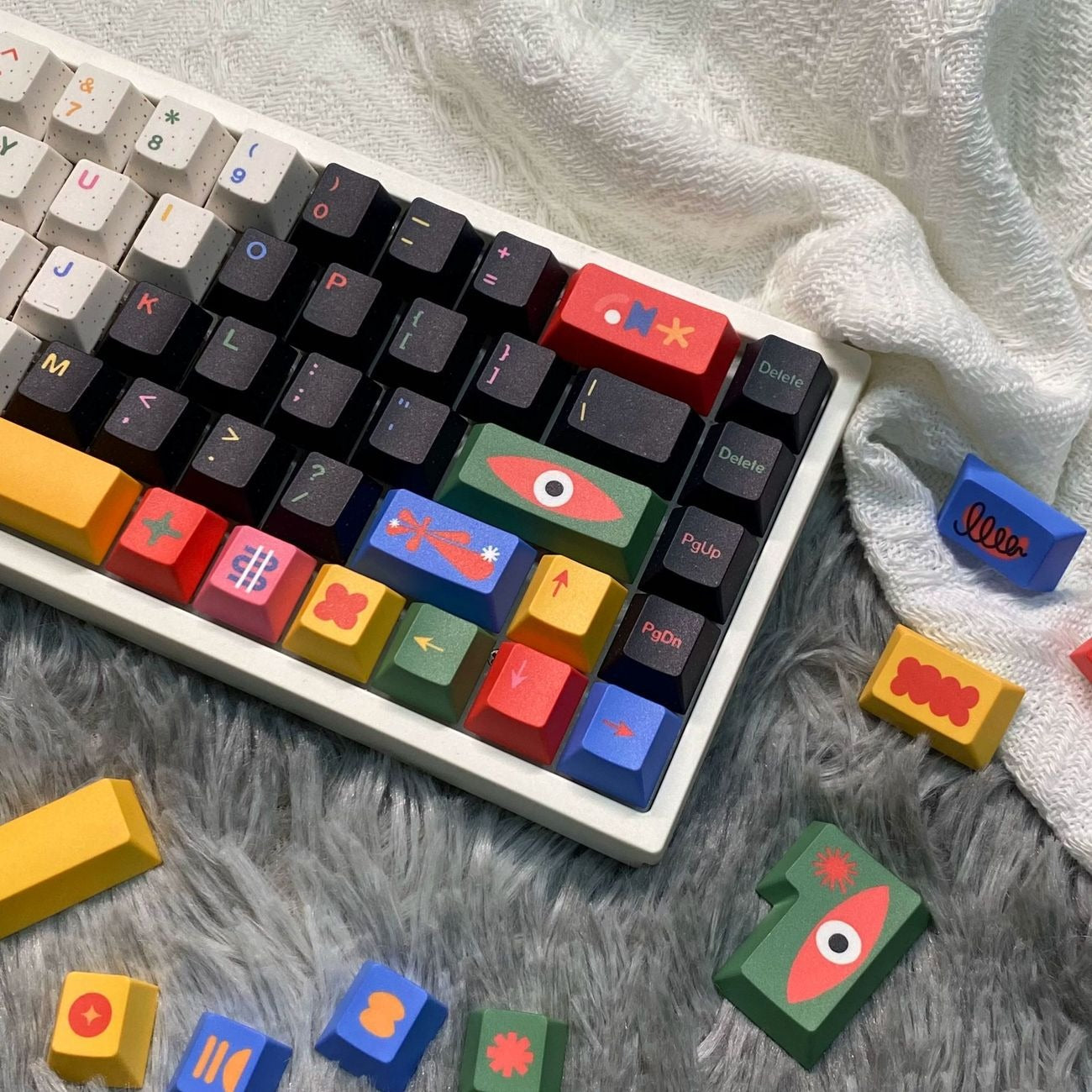 Artistic colorful keycap set used in a modern desktop setup with a creative mechanical keyboard aesthetic