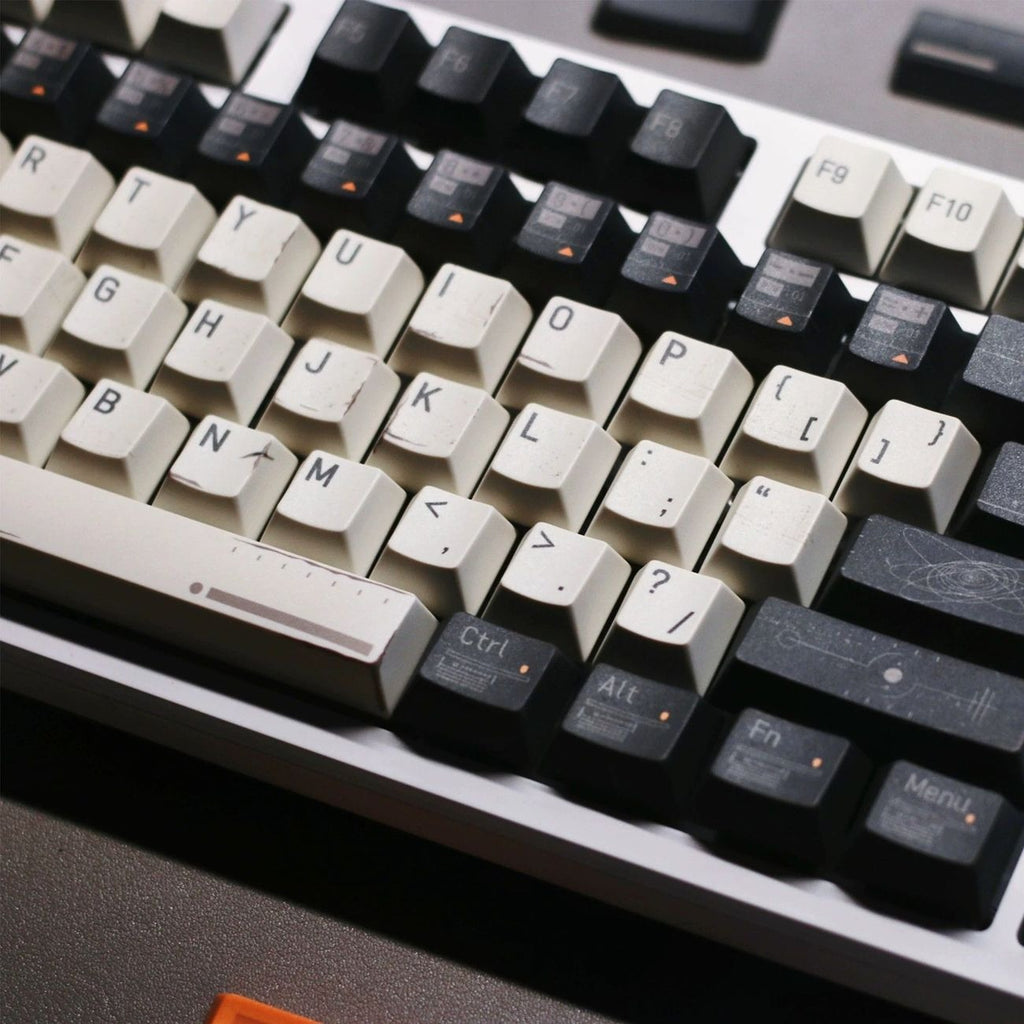 Close-up view of Interstellar inspired keycaps featuring spacecraft telemetry graphics, cosmic maps, orbital patterns, and futuristic details