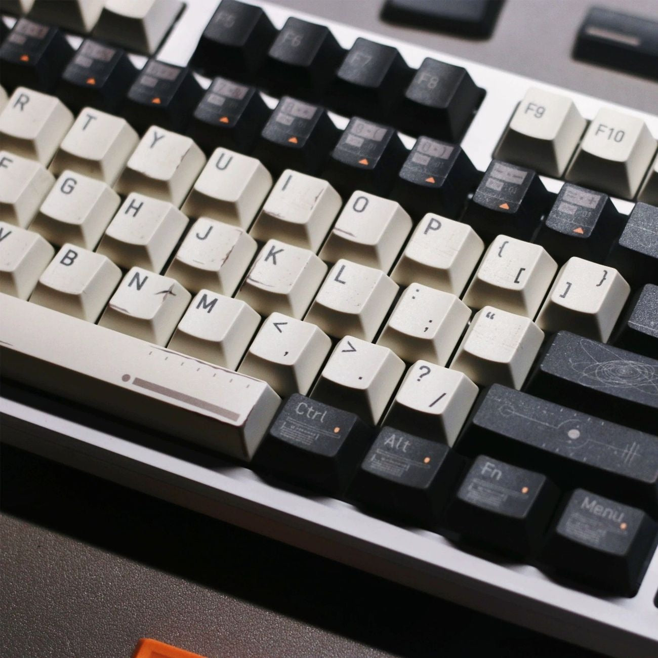 Close-up view of Interstellar inspired keycaps featuring spacecraft telemetry graphics, cosmic maps, orbital patterns, and futuristic details