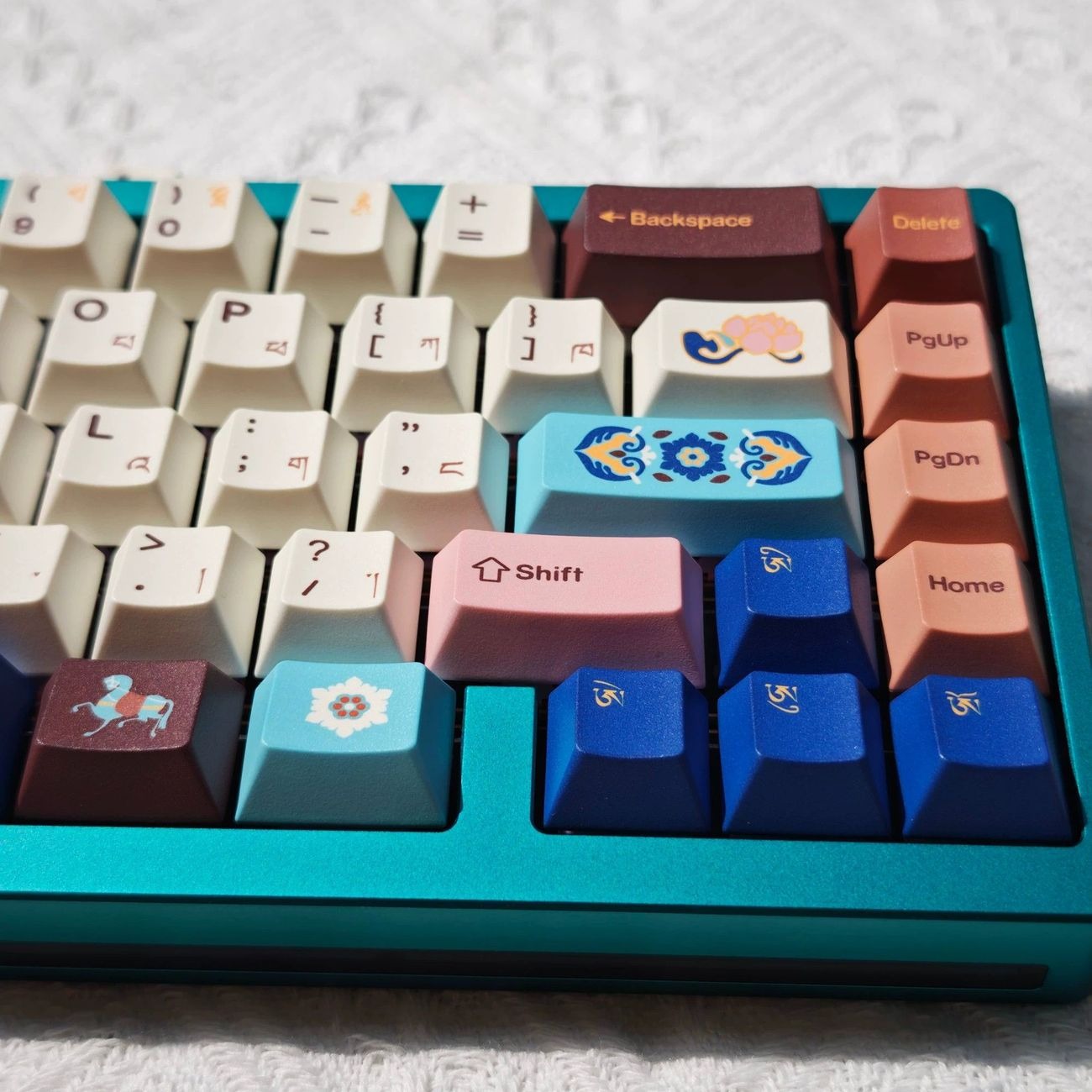 Close-up view of Tibetan inspired keycaps showing traditional decorative patterns, colorful artwork, and detailed dye sublimation printing